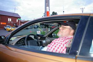 Charlie Cotterman listens to the net at Kenton service as Kyle Sarasin / Mikael Johansson leave in their Subaru Impreza.