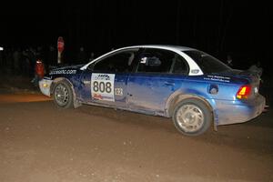 Mike Isaacs / Craig Walli drift their Saturn SL2 through the 90-right spectator point on SS7.