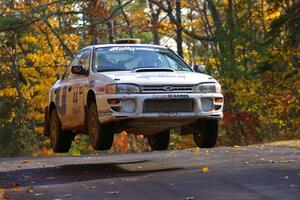 Henry Krolikowski / Cindy Krolikowski catch nice air at the midpoint jump on Brockway 1, SS13, in their Subaru Impreza.