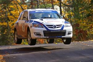 Eric Burmeister / Dave Shindle catch nice air at the midpoint jump on Brockway 1, SS13, in their Mazda Speed 3.