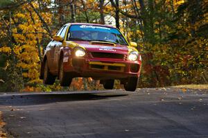 Bryan Pepp / Jerry Stang get nice air at the midpoint jump on SS13, Brockway 1, in their Subaru WRX .