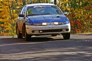 Mike Isaacs / Craig Walli take it easy at the midpoint jump on Brockway 1, SS13, in their Saturn SL2.