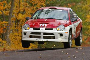 Doug Shepherd / Karen Wagner take a more conservative run at the midpoint jump on Brockway 2, SS14, in their Dodge SRT-4.