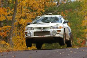 Henry Krolikowski / Cindy Krolikowski prepare for liftoff at the midpoint jump on Brockway 2, SS14, in their Subaru Impreza.