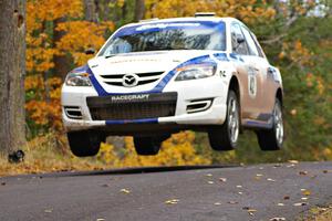 Eric Burmeister / Dave Shindle catch nice air at the midpoint jump on Brockway 2, SS14, in their Mazda Speed 3.