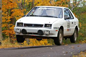 Greg Woodside / Tom Woodside catch nice air at the midpoint jump on Brockway 2, SS14, in their Dodge Shadow.