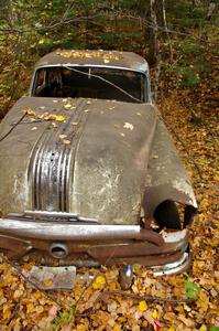 A mid-fifties Pontiac rusts away in the fall forest near the Michigan/Wisconsin border.