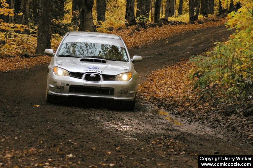 Tire replaced, Piotr Wiktorczyk / Alan Dolan limp their Subaru WRX STi to the finish of SS2.