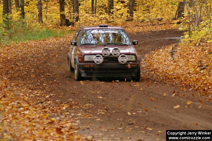 Billy Mann / Josh VanDenHeuvel accelerate out of a sweeper on SS2, Beacon Hill, in their VW GTI.