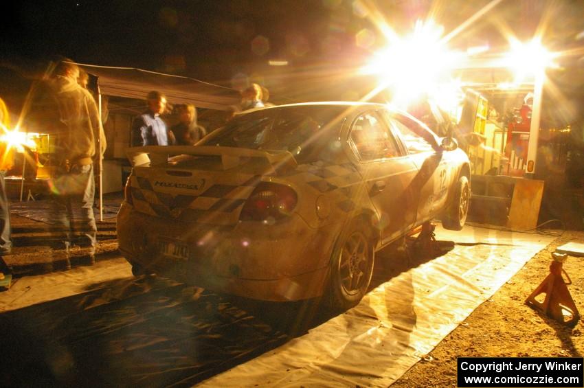 The Zach Babcock / Jeff Miller Dodge SRT-4 receives left-side repairs at the second Kenton service.