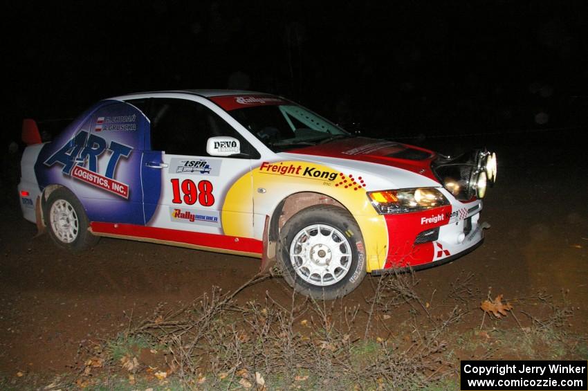 Arkadiusz Gruszka / Michal Chodan drift through a 90-right at the spectator point on SS7 in their Mitsubishi Lancer Evo 9.