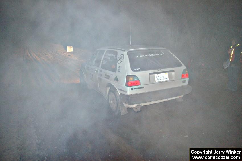 Exhaust smoke in the sub-freezing temps cloud the Michel Hoche-Mong / Jimmy Brandt VW GTI at the start of SS9, Menge Creek.