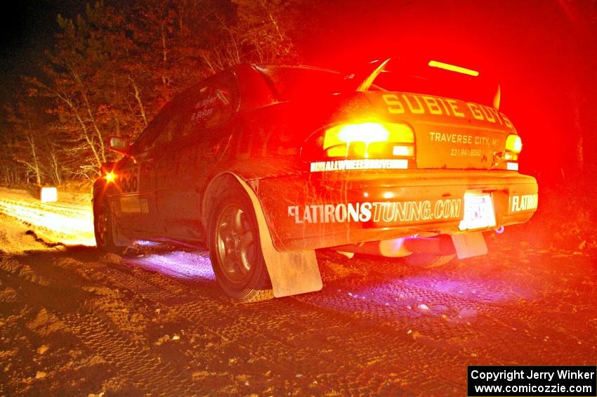 Matt Marker / Ben Slocum turn on the underside lights at the start of SS9, Menge Creek, in their Subaru Impreza.