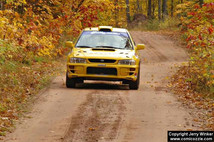 Kyle Sarasin / Mikael Johansson at speed down a straight in their Subaru Impreza near the finish of SS10, Gratiot Lake 1.