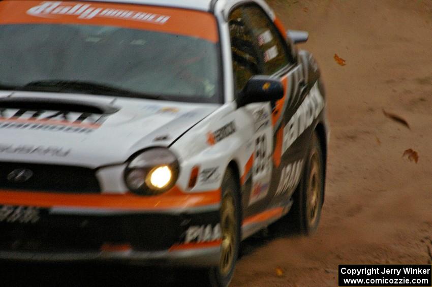 Pat Moro / Mike Rossey spray gravel at a sweeper in their Subaru WRX near the finish of SS10, Gratiot Lake 1.