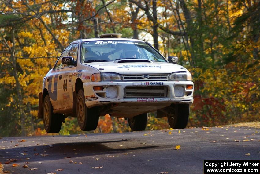 Henry Krolikowski / Cindy Krolikowski catch nice air at the midpoint jump on Brockway 1, SS13, in their Subaru Impreza.