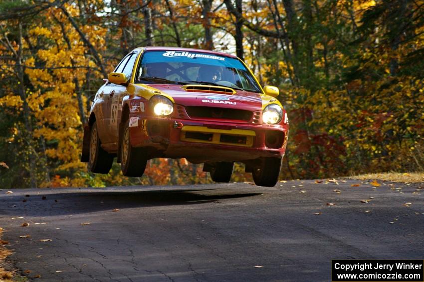 Bryan Pepp / Jerry Stang get nice air at the midpoint jump on SS13, Brockway 1, in their Subaru WRX .