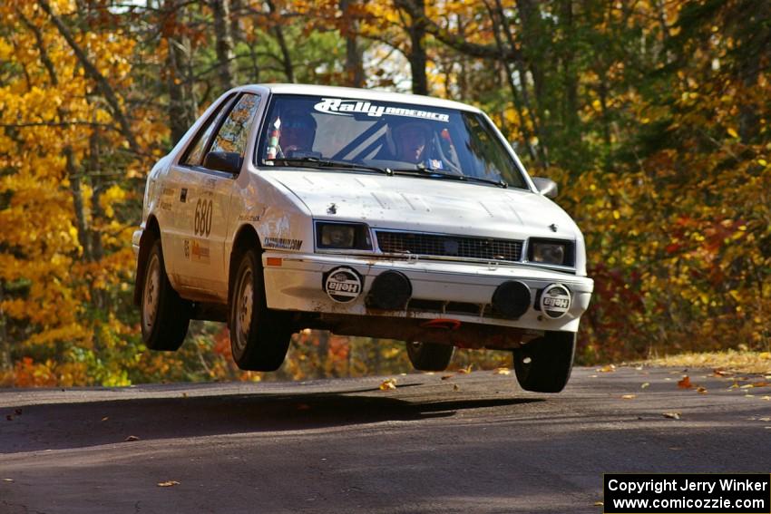 Greg Woodside / Tom Woodside catch air at the midpoint jump on Brockway 1, SS13, in their Dodge Shadow.