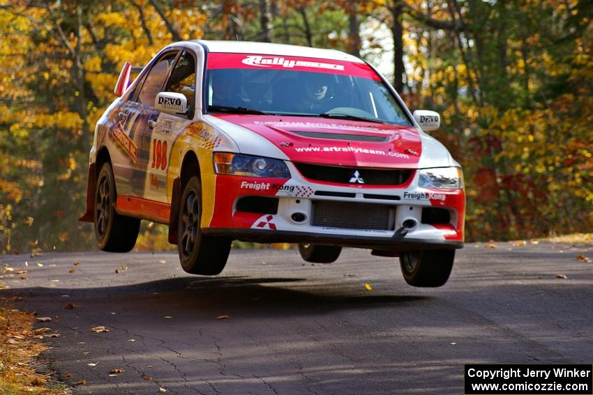 The Arkadiusz Gruszka / Michal Chodan Mitsubishi Lancer Evo 9 gets decent air at the midpoint jump of Brockway 1, SS13.