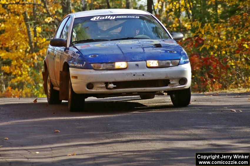 Mike Isaacs / Craig Walli take it easy at the midpoint jump on Brockway 1, SS13, in their Saturn SL2.