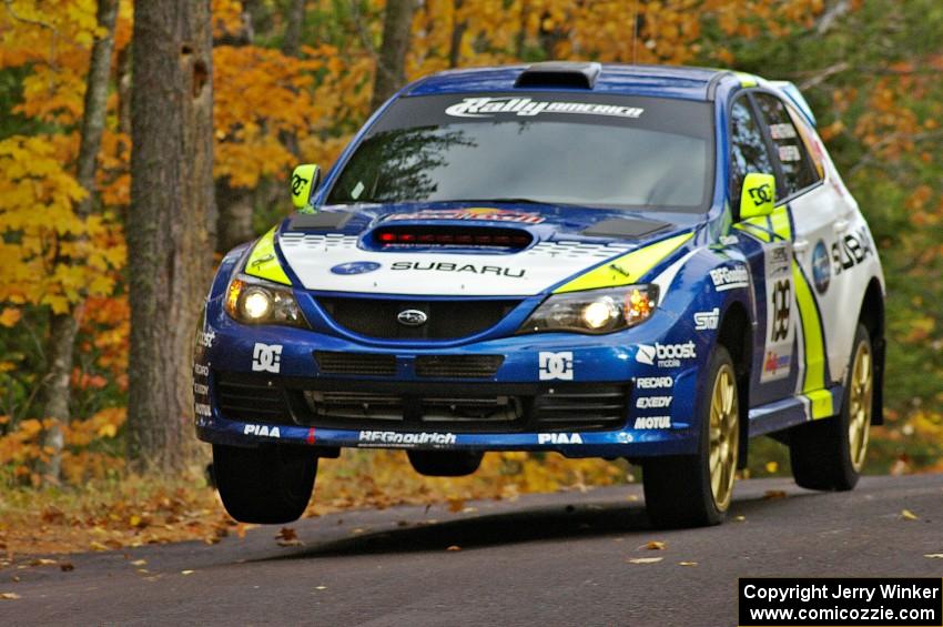 Travis Pastrana / John Buffum catch minimal air at the midpoint jump on SS14, Brockway 2, in their Subaru WRX STi.