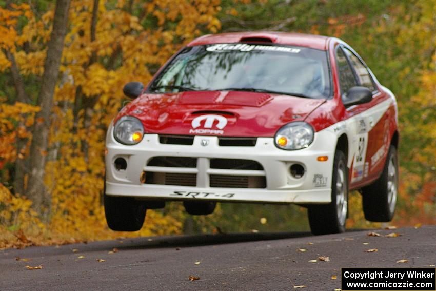 Doug Shepherd / Karen Wagner take a more conservative run at the midpoint jump on Brockway 2, SS14, in their Dodge SRT-4.