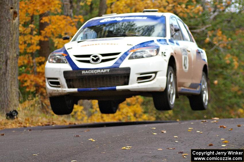 Eric Burmeister / Dave Shindle catch nice air at the midpoint jump on Brockway 2, SS14, in their Mazda Speed 3.