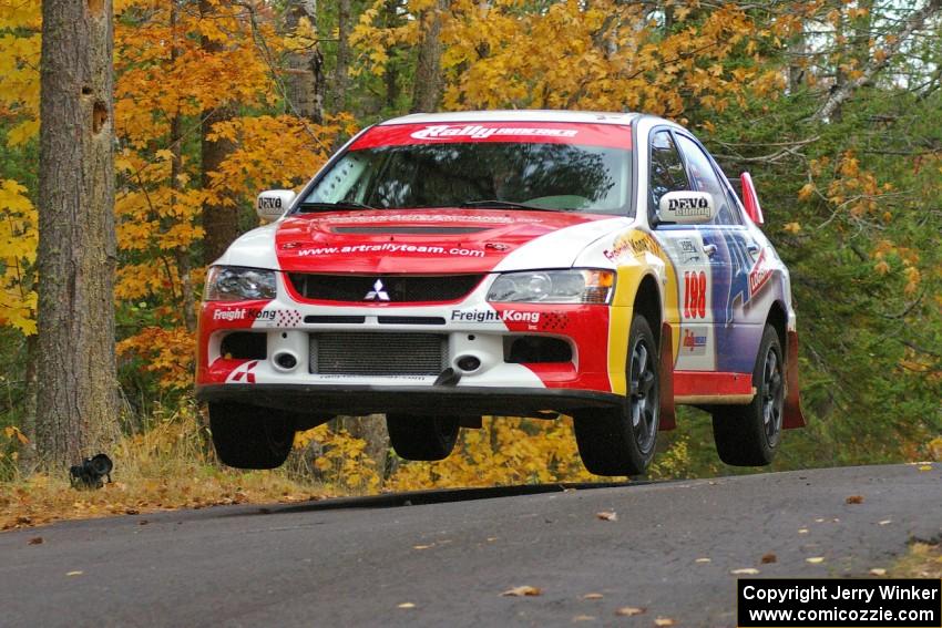 Arkadiusz Gruszka / Michal Chodan get decent air at the midpoint jump on SS14, Brockway 2, in their Mitsubishi Lancer Evo 9.