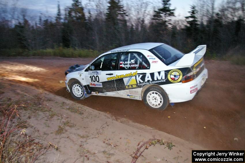 Andi Mancin / Maciej Wislawski drift through a sweeper in their Mitsubishi Evo 9 on Gratiot Lake 2, SS17.