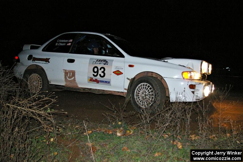 The Bob Olson / Conrad Ketelsen Subaru 2.5 RS drifts through a 90-right at the spectator point on SS7.