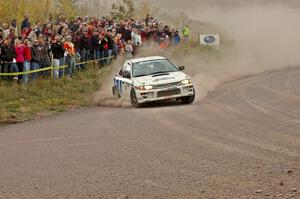 Henry Krolikowski / Cindy Krolikowski set up for a hard left-hander at the spectator point on SS1 in their Subaru Impreza.