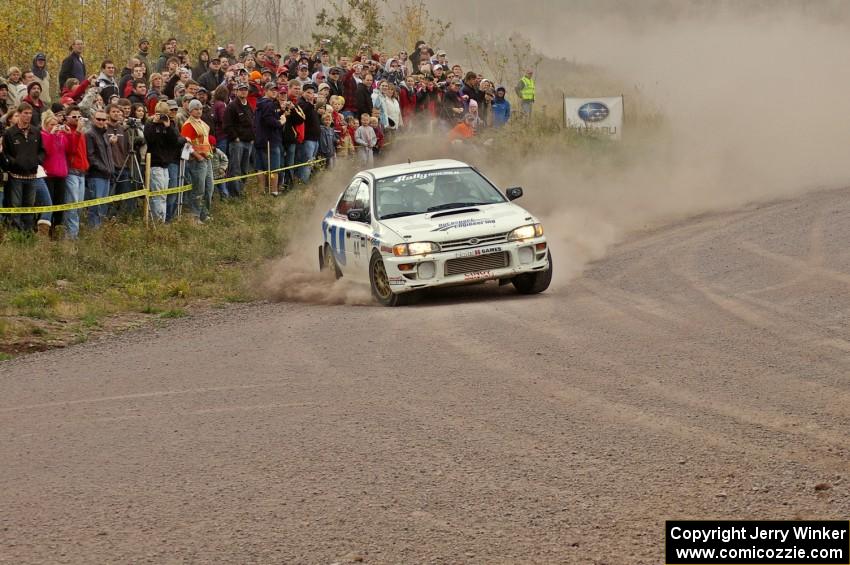 Henry Krolikowski / Cindy Krolikowski set up for a hard left-hander at the spectator point on SS1 in their Subaru Impreza.