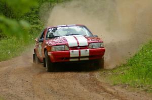 Mark Utecht / Rob Bohn drift their Ford Mustang through a sweeper while coming out of a huge dip on SS1.