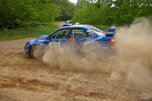 Carl Siegler / David Goodman drift through a dusty hard-left on SS1 in their Subaru WRX STi.