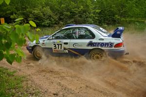 Mason Moyle / Scott Putnam drift their Subaru Impreza through a left hairpin on SS1.