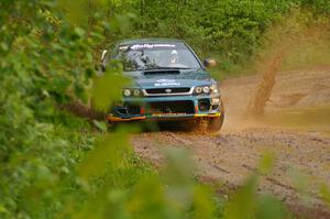 The Janusz Topor / Michal Kaminski Subaru Impreza hits a large puddle on SS5.