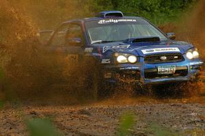 Carl Siegler / David Goodman hit a puddle on SS5 hard in their Subaru WRX STi.