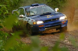 Mason Moyle / Scott Putnam slide their Subaru Impreza through a huge puddle on SS5.