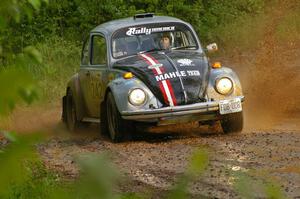 Mark Huebbe / John Huebbe slide their VW Beetle through a large puddle on SS5.