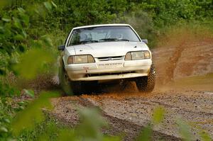 The Bonnie Stoehr / Jake Weber Ford Mustang hits a large puddle on SS5.