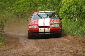 Mark Utecht / Rob Bohn drift their Ford Mustang through a sloppy corner after a large puddle on SS6.