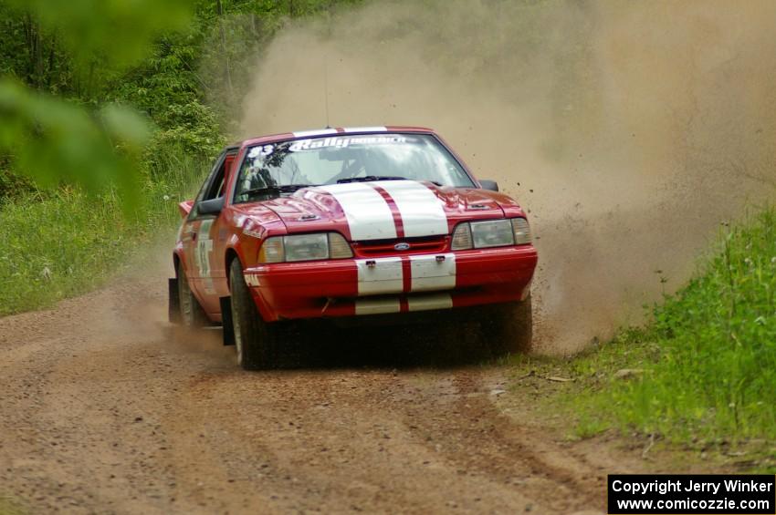 Mark Utecht / Rob Bohn drift their Ford Mustang through a sweeper while coming out of a huge dip on SS1.