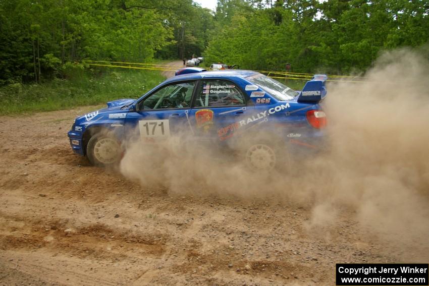 Carl Siegler / David Goodman drift through a dusty hard-left on SS1 in their Subaru WRX STi.