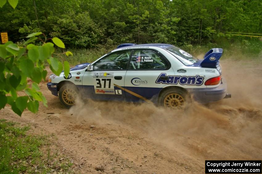Mason Moyle / Scott Putnam drift their Subaru Impreza through a left hairpin on SS1.