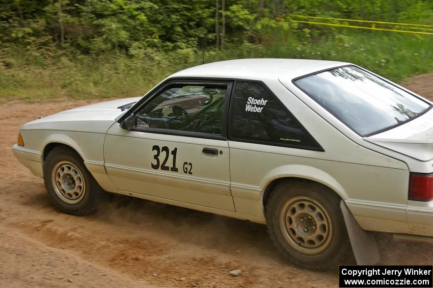 Bonnie Stoehr / Jake Weber take the left onto Potlatch Rd. on SS1 in their Ford Mustang.