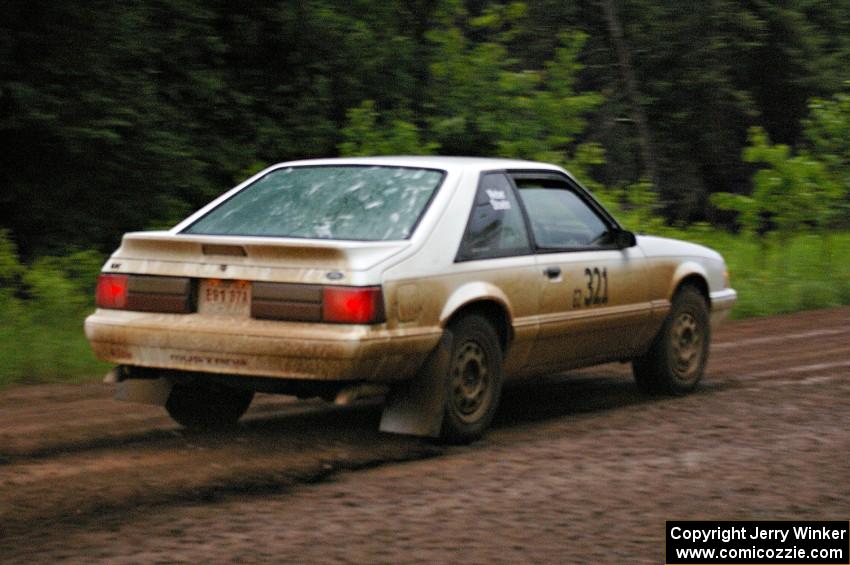 Bonnie Stoehr / Jake Weber drift their Ford Mustang on a fast left sweeper on SS4.