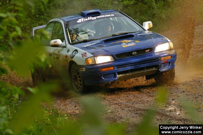 Mason Moyle / Scott Putnam slide their Subaru Impreza through a huge puddle on SS5.