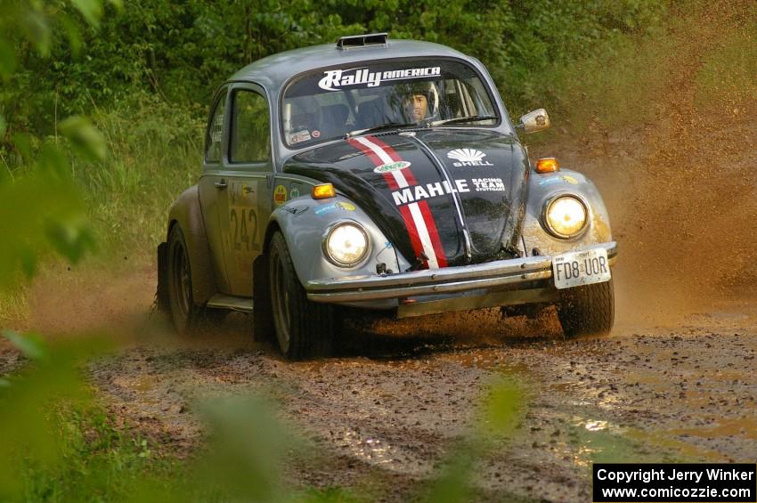 Mark Huebbe / John Huebbe slide their VW Beetle through a large puddle on SS5.