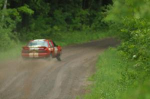 Mark Utecht / Rob Bohn set up their Ford Mustang for a sweeper on SS3 during a heavy rainfall.