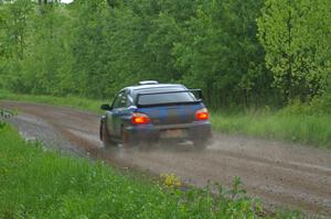 Carl Siegler / David Goodman at speed in the rain on SS3 in their Subaru WRX STi.